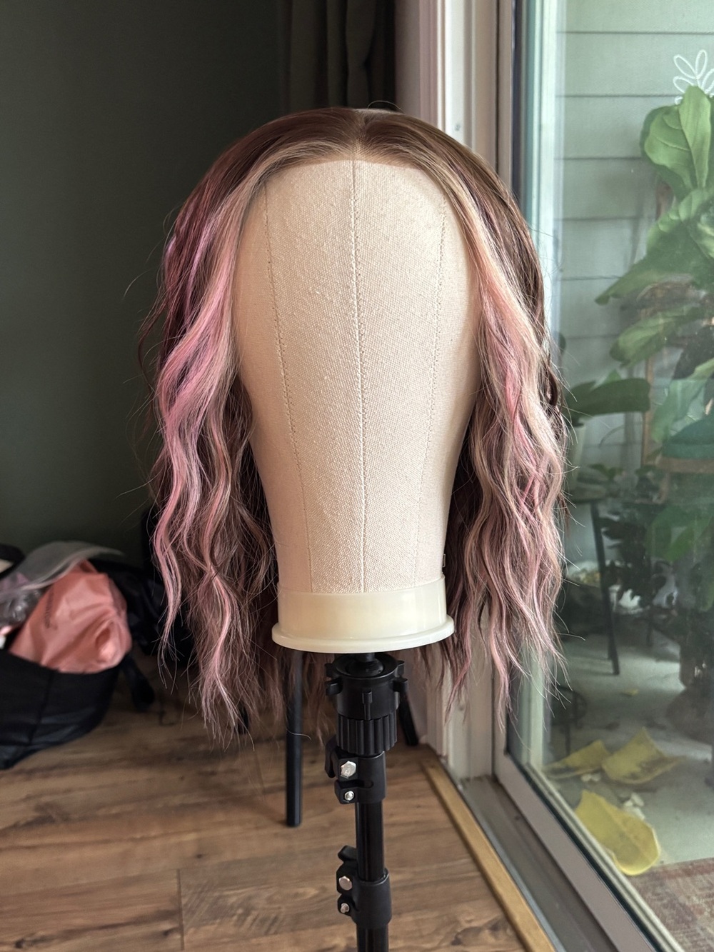 Carkira brown with pink face framing highlights. Petite but fits standard.
